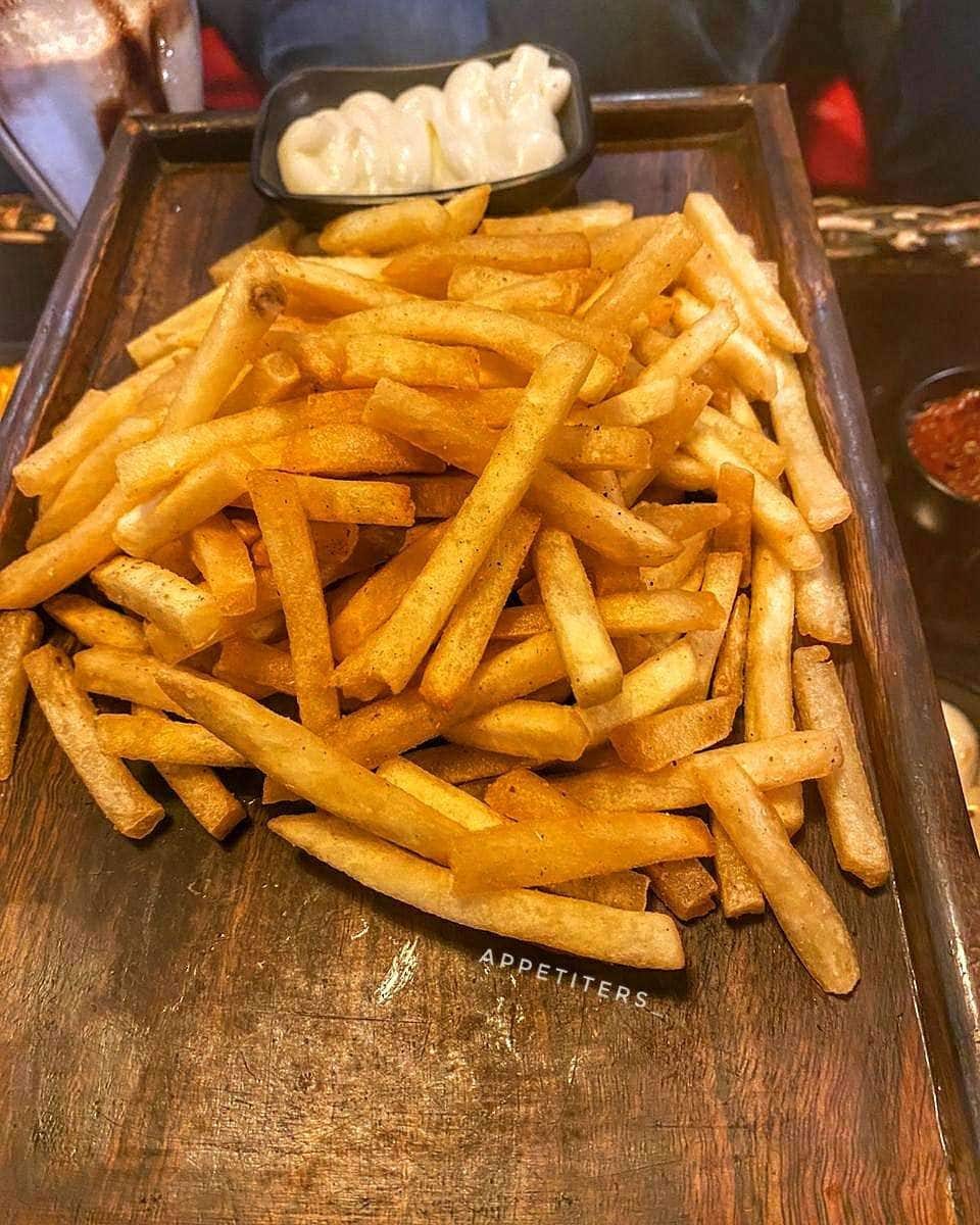 A tray of fries with dips