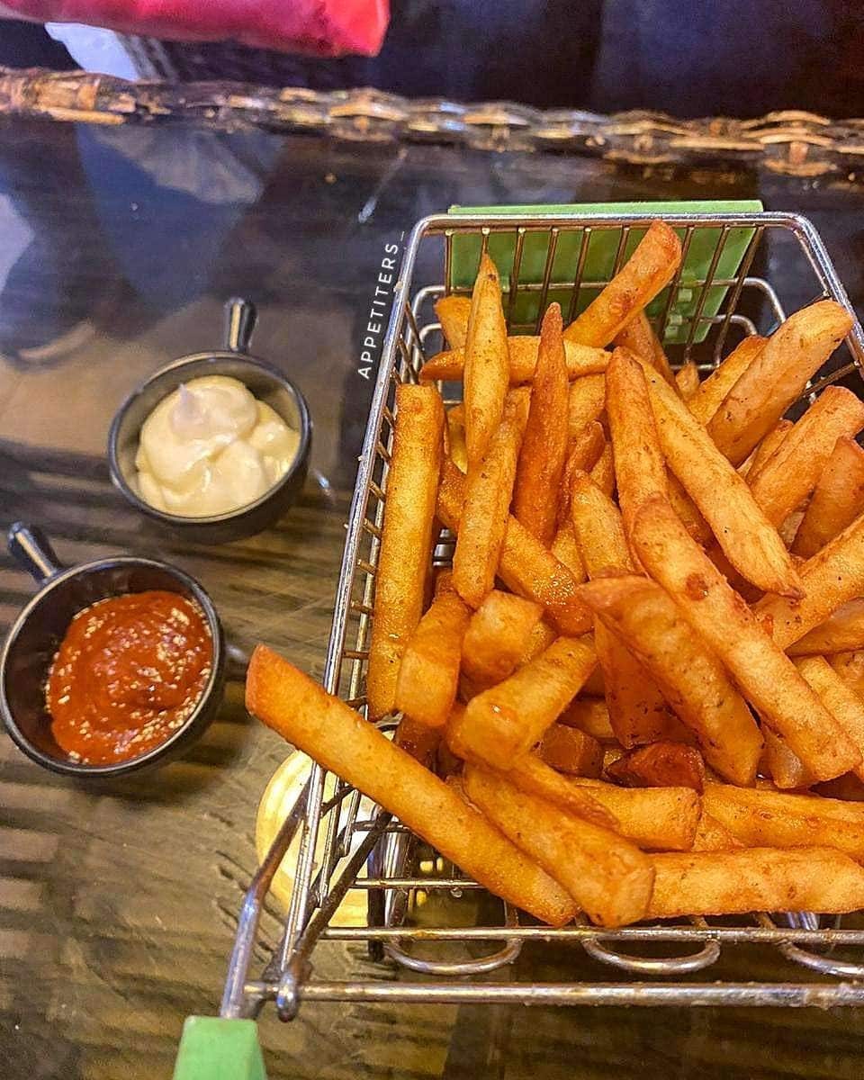 A basket of fries with dips