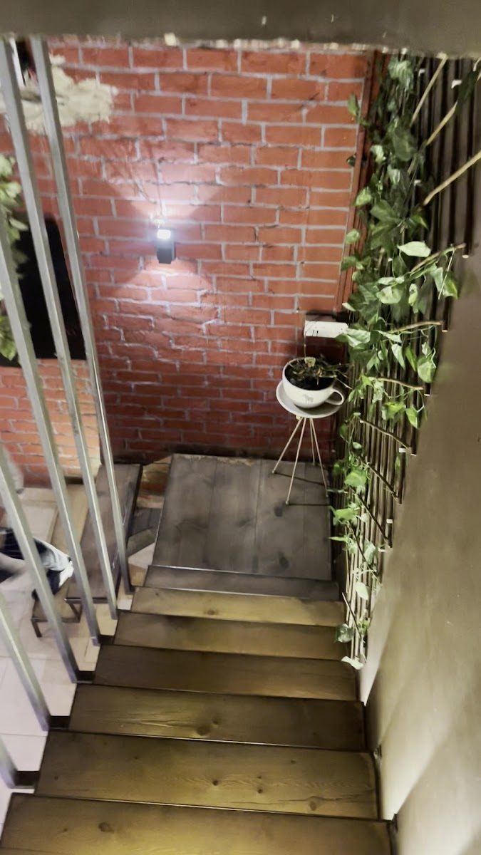 The brick stairwell up to the first floor